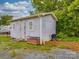 Wooden shed with double doors and windows in a backyard setting with gravel at 201 Robinson Rd, Gastonia, NC 28056