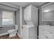 Compact bathroom with a stacked washer and dryer unit, vanity, and toilet at 222 W Mccubbins St, Salisbury, NC 28144