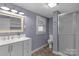 Bathroom features a white vanity, a window, and a glass-enclosed shower at 222 W Mccubbins St, Salisbury, NC 28144
