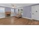 Bright living room featuring a fireplace, built-in shelving, and a cozy armchair at 222 W Mccubbins St, Salisbury, NC 28144