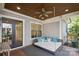 Relaxing back porch featuring a daybed swing with comfortable cushions and a ceiling fan at 2221 Kenmore Ave, Charlotte, NC 28204