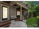 Covered outdoor seating area with comfortable furnishings, an outdoor dining table, and access to the backyard at 2221 Kenmore Ave, Charlotte, NC 28204