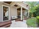 Backyard featuring a covered back porch with comfortable seating, outdoor dining and a grassy yard at 2221 Kenmore Ave, Charlotte, NC 28204