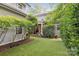 Backyard featuring a covered back porch, privacy landscaping and manicured lawn at 2221 Kenmore Ave, Charlotte, NC 28204