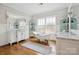 Elegant bathroom featuring a freestanding tub, double vanity, and hardwood floors at 2221 Kenmore Ave, Charlotte, NC 28204