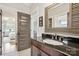 Bathroom with a dark vanity, granite countertop and modern fixtures, opens to bedroom at 2221 Kenmore Ave, Charlotte, NC 28204