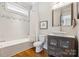 This bathroom has a tub/shower, a decorative mirror and hardwood floors at 2221 Kenmore Ave, Charlotte, NC 28204