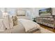 This bedroom features a bed with a white comforter, custom shutters and hardwood floors at 2221 Kenmore Ave, Charlotte, NC 28204