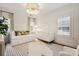 Cozy Bedroom featuring a daybed, crib, plush rug, and ample natural light at 2221 Kenmore Ave, Charlotte, NC 28204