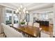This dining room features an elegant light fixture, large window and a view to the kitchen at 2221 Kenmore Ave, Charlotte, NC 28204