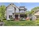 Charming home featuring a covered front porch, brick accents, and professionally landscaped front yard at 2221 Kenmore Ave, Charlotte, NC 28204