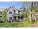 Charming home featuring a covered front porch, brick accents, and professionally landscaped front yard at 2221 Kenmore Ave, Charlotte, NC 28204