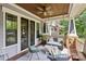 Inviting front porch with a swing, ceiling fan, comfortable seating, and stylish decor at 2221 Kenmore Ave, Charlotte, NC 28204