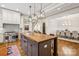 This spacious kitchen features an island, stainless steel appliances, custom cabinets, and hardwood floors at 2221 Kenmore Ave, Charlotte, NC 28204