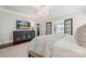 This main bedroom features a bed, a TV and access to a walk-in closet and bathroom at 2221 Kenmore Ave, Charlotte, NC 28204