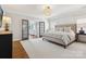 This main bedroom features a bed, hardwood floors and bathroom access via French doors at 2221 Kenmore Ave, Charlotte, NC 28204