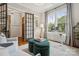 Stylish home office with ample natural light, custom shelving, and a comfortable seating area at 2221 Kenmore Ave, Charlotte, NC 28204