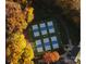 Aerial view of tennis courts surrounded by fall foliage at 2226 Elendil Ln, Charlotte, NC 28269