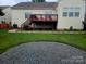Wide view of the backyard including a wood deck, grass and a firepit area at 2226 Elendil Ln, Charlotte, NC 28269