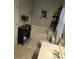 Bathroom featuring a tub, single sink, tile floor and decorative floral accents at 2226 Elendil Ln, Charlotte, NC 28269