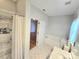 Bright bathroom featuring tile floors, walk-in shower, tub and single vanity at 2226 Elendil Ln, Charlotte, NC 28269