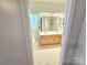 Well-lit bathroom featuring a double vanity, a shower, toilet and tile flooring; spacious layout at 2226 Elendil Ln, Charlotte, NC 28269