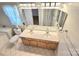 Bright bathroom with a double sink vanity, tile floors, a soaking tub and toilet at 2226 Elendil Ln, Charlotte, NC 28269