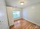 Cozy bedroom with hardwood floors, built-in shelves, and a bright window at 2226 Elendil Ln, Charlotte, NC 28269