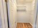 Walk-in closet featuring built-in shelving and hanging racks for clothing storage and organization at 2226 Elendil Ln, Charlotte, NC 28269