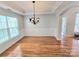 Bright dining room featuring a decorative chandelier, hardwood floors and plenty of natural light at 2226 Elendil Ln, Charlotte, NC 28269