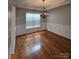 Charming dining area features hardwood floors, wainscoting detail, and an elegant chandelier at 2226 Elendil Ln, Charlotte, NC 28269