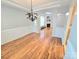 Open-concept dining room with decorative chandelier and hardwood floors at 2226 Elendil Ln, Charlotte, NC 28269
