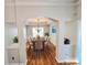 Elegant dining room with hardwood floors, a tray ceiling, and an ornate chandelier, ideal for Gathering gatherings at 2226 Elendil Ln, Charlotte, NC 28269