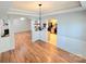 Dining area with hardwood floors and chandelier lighting, flows into kitchen and living room at 2226 Elendil Ln, Charlotte, NC 28269