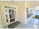 A covered front porch features a storm door entry, cream siding and red shutters at 2226 Elendil Ln, Charlotte, NC 28269