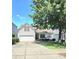 Charming white home with red shutters, a well-manicured lawn, and a welcoming two-car garage at 2226 Elendil Ln, Charlotte, NC 28269