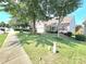 A neatly kept lawn surrounds a white home with red shutters and a two-car garage at 2226 Elendil Ln, Charlotte, NC 28269