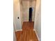 Hallway with wood floors leads to a bathroom with a shower and a closet at 2226 Elendil Ln, Charlotte, NC 28269