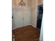 Hallway with wood floors leads to a bathroom with a shower and a closet at 2226 Elendil Ln, Charlotte, NC 28269