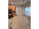 Bright kitchen features tile flooring, wooden cabinets, and a window at 2226 Elendil Ln, Charlotte, NC 28269