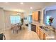 Bright eat-in kitchen with tile floors, wood cabinets, granite countertops, and a large window for natural light at 2226 Elendil Ln, Charlotte, NC 28269