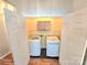 Bright laundry room featuring a modern washer and dryer and extra storage space with cabinets and shelving at 2226 Elendil Ln, Charlotte, NC 28269