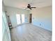 Spacious living room with a ceiling fan, neutral paint, and access to the back yard at 2226 Elendil Ln, Charlotte, NC 28269