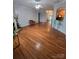Open-concept living area with hardwood floors, fireplace, and views into the kitchen at 2226 Elendil Ln, Charlotte, NC 28269