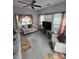 Bright living room with ceiling fan, modern flooring, stylish sofas, and natural light from large windows at 2226 Elendil Ln, Charlotte, NC 28269