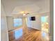 Open living area with hardwood floors, a ceiling fan, a large window, and neutral paint at 2226 Elendil Ln, Charlotte, NC 28269