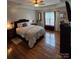 Inviting bedroom features hardwood floors, a tray ceiling, and a cozy bed at 2226 Elendil Ln, Charlotte, NC 28269