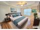Comfortable bedroom with a tray ceiling, ceiling fan, king-sized bed, and neutral decor at 2226 Elendil Ln, Charlotte, NC 28269