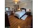 Spacious bedroom with hardwood floors, a cozy bed, and stylish decor at 2226 Elendil Ln, Charlotte, NC 28269
