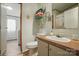 Cozy bathroom featuring a white vanity with a sink, toilet, and a mirrored storage shelf at 231 Valley View Dr, Clover, SC 29710
